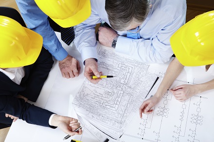 Image showing men working on a building plan